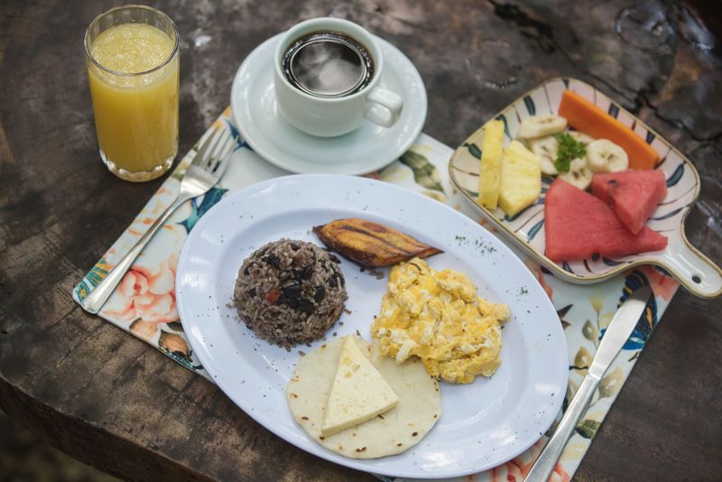 Costa Rican breakfast with gallo pinto, eggs and fresh fruit
